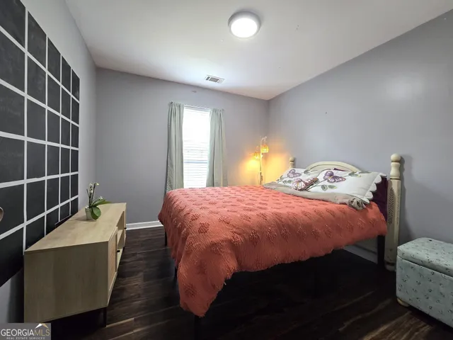 a bed sitting in a bedroom next to a window
