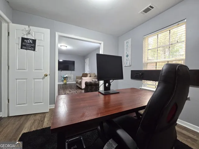 a view of a dining room with furniture and wooden floor