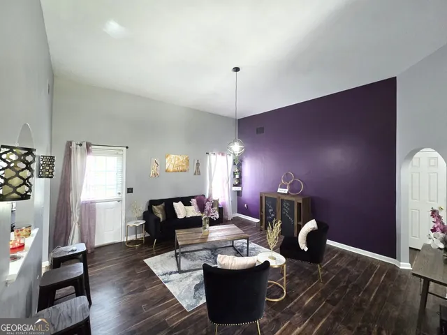 a living room with furniture and wooden floor