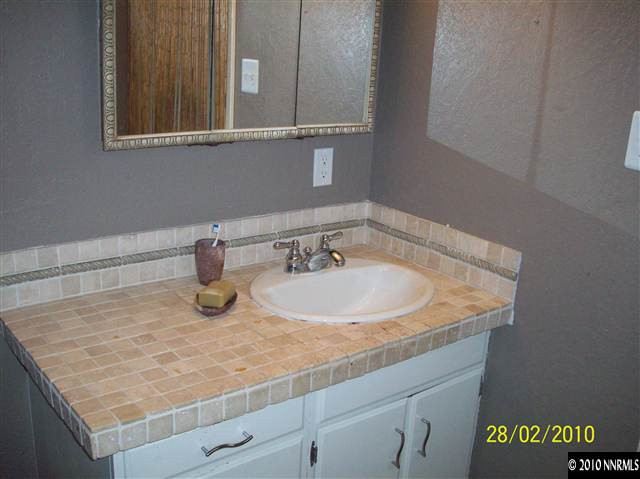 2285 Arcane Avenue Reno, NV 89503 - Photo 3 of 9 a bathroom with a sink and a mirror