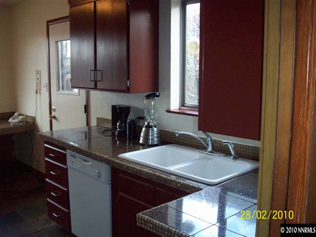 2285 Arcane Avenue Reno, NV 89503 - Photo 8 of 9 a kitchen with a table chairs and cabinets