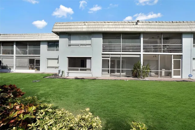 a view of a house with backyard sitting area and garden