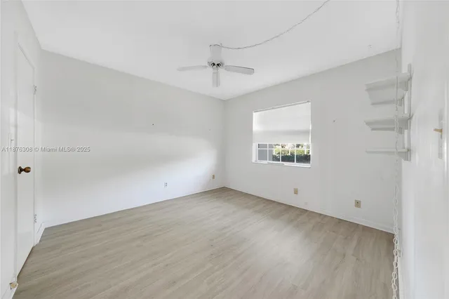 a bathroom with a granite countertop sink mirror and a bathtub