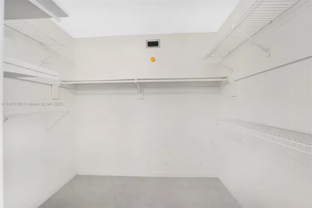 a bathroom with a granite countertop toilet a sink and shower