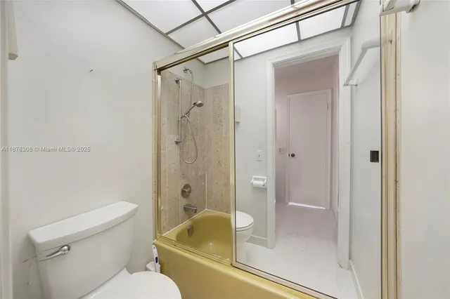 a bathroom with a glass shower door