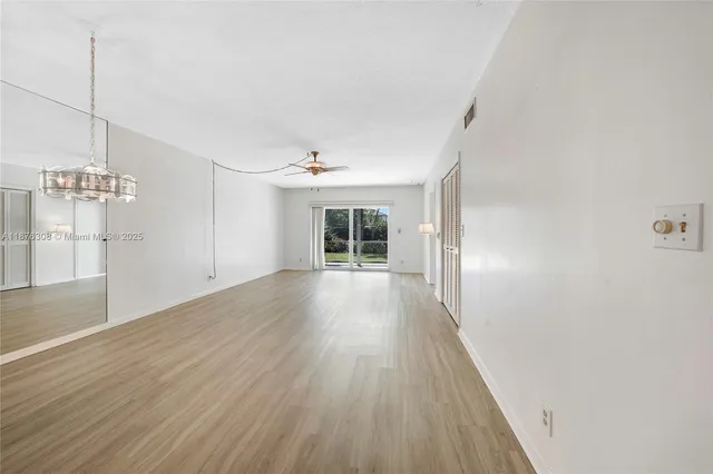 a kitchen with stainless steel appliances a sink a stove a refrigerator and cabinets