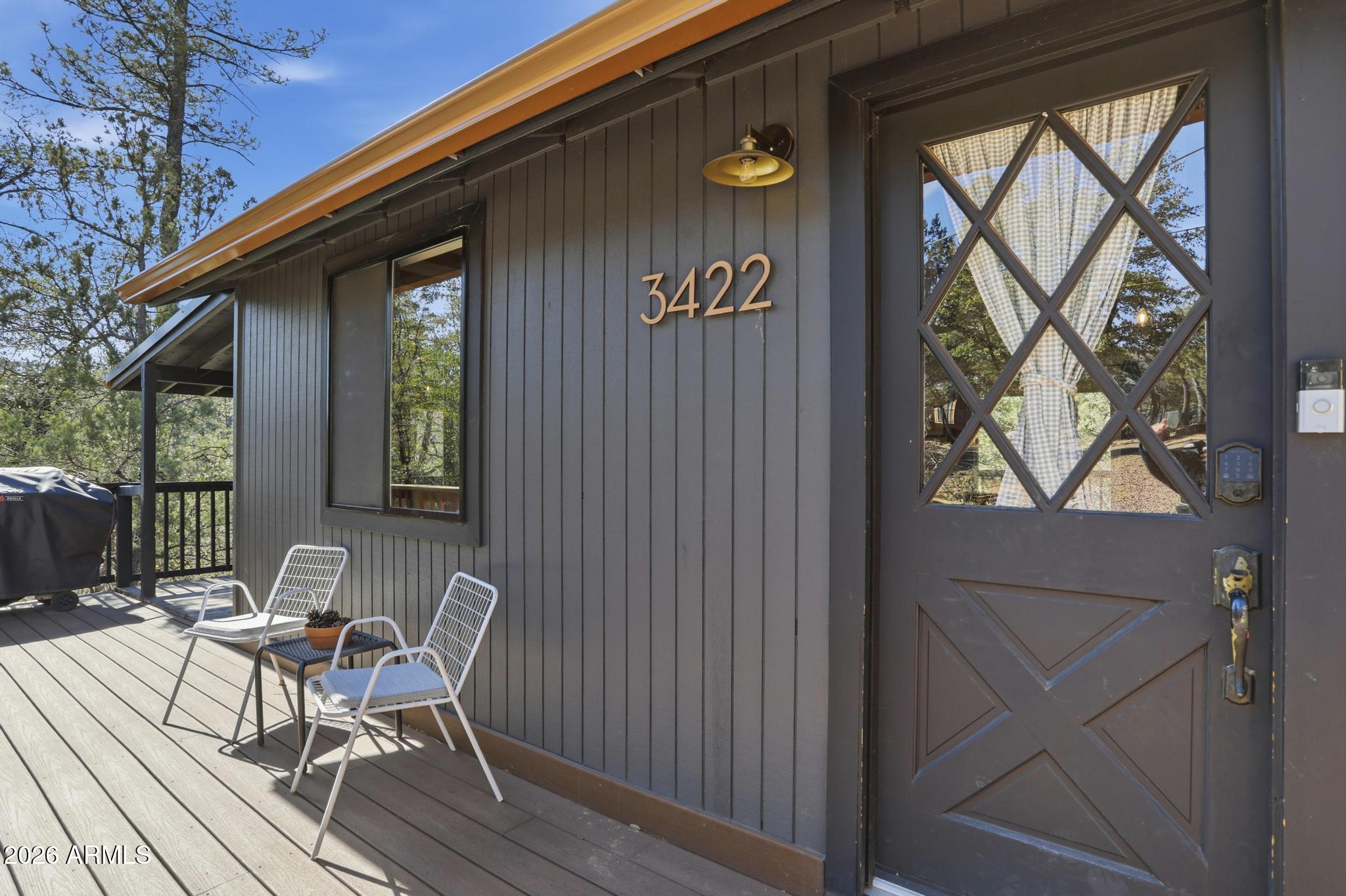 3422 Limestone Way Pine, AZ 85544 - Photo 27 of 35 a view of a patio with table and chairs and wooden floor