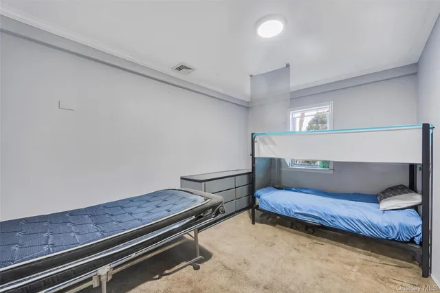 a bedroom with a bed and cabinets