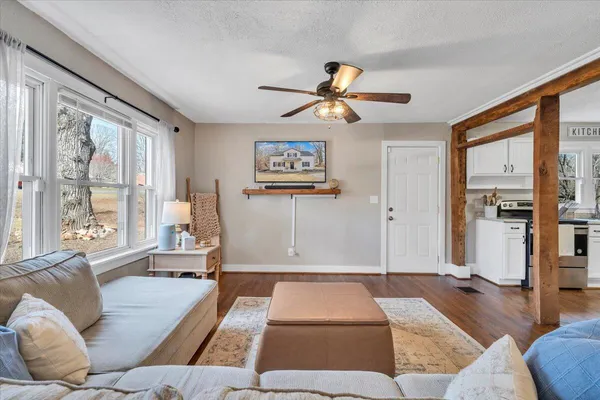 a living room with furniture and a wooden floor
