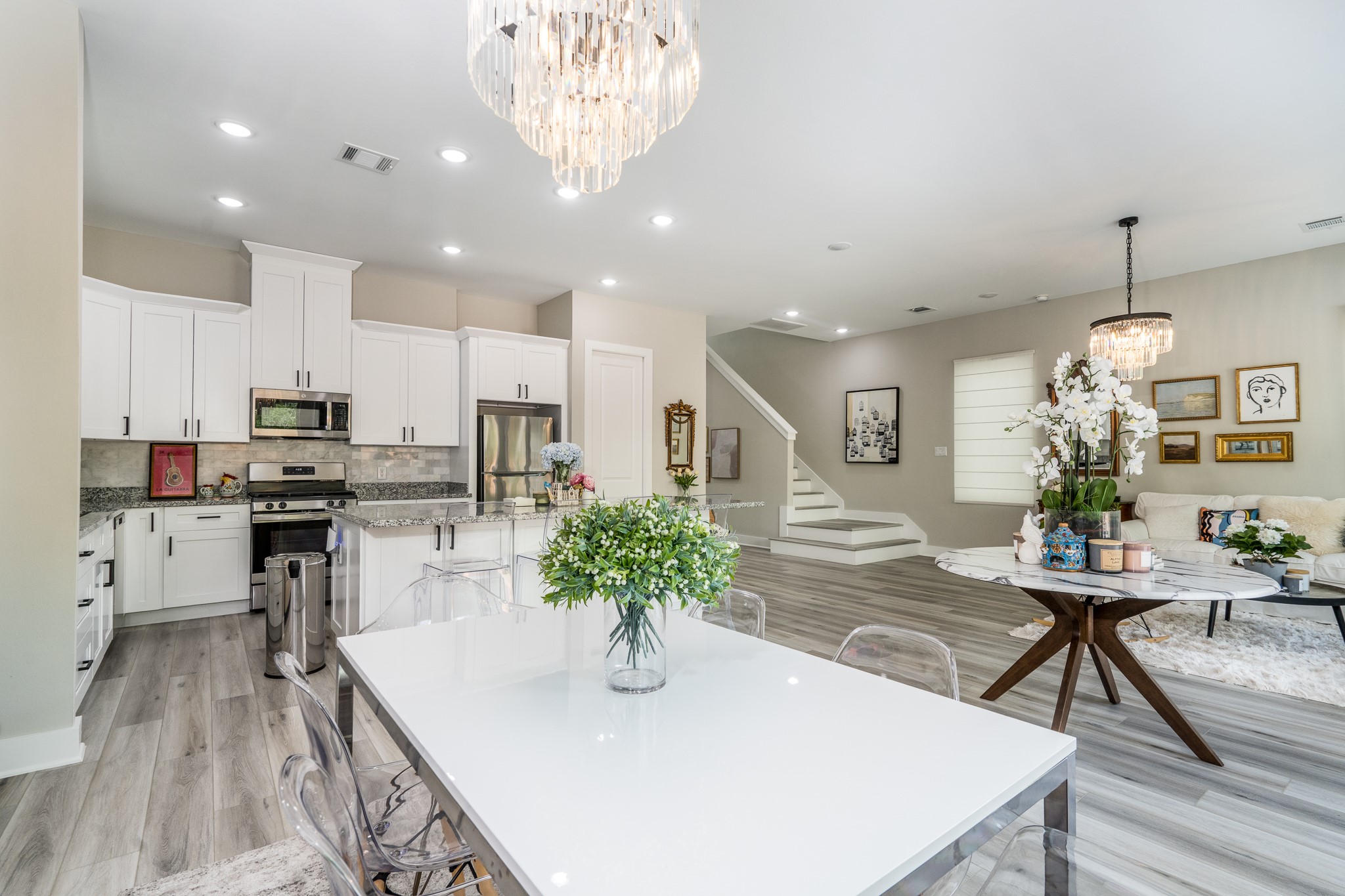 4926 Wunder Way Houston, TX 77069 - Photo 13 of 39 a kitchen with stainless steel appliances kitchen island granite countertop a table chairs and a refrigerator