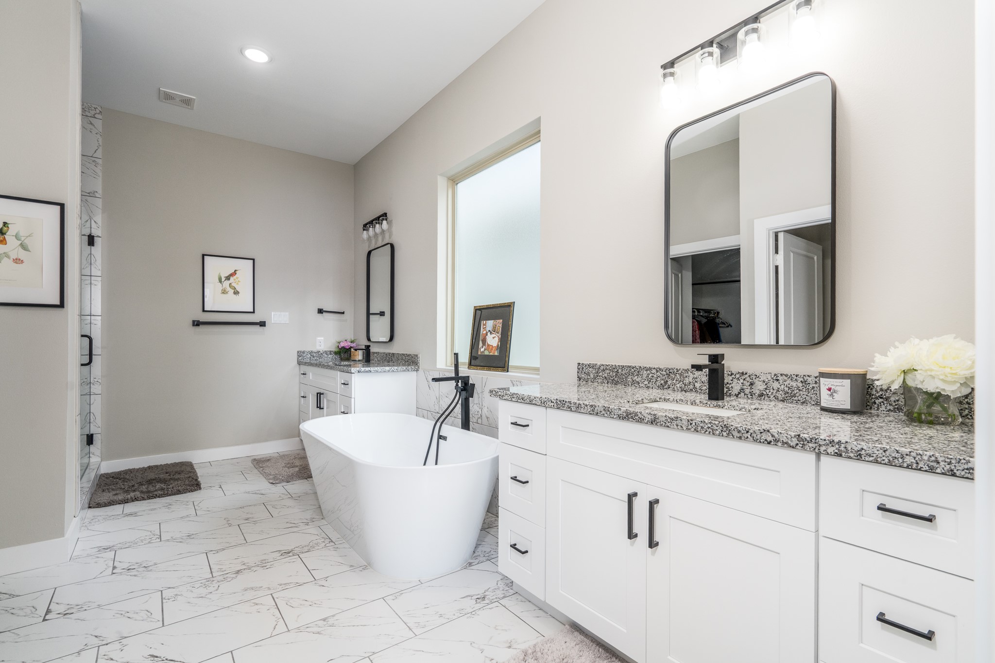 4926 Wunder Way Houston, TX 77069 - Photo 18 of 39 a bathroom with a white tub a sink and mirror