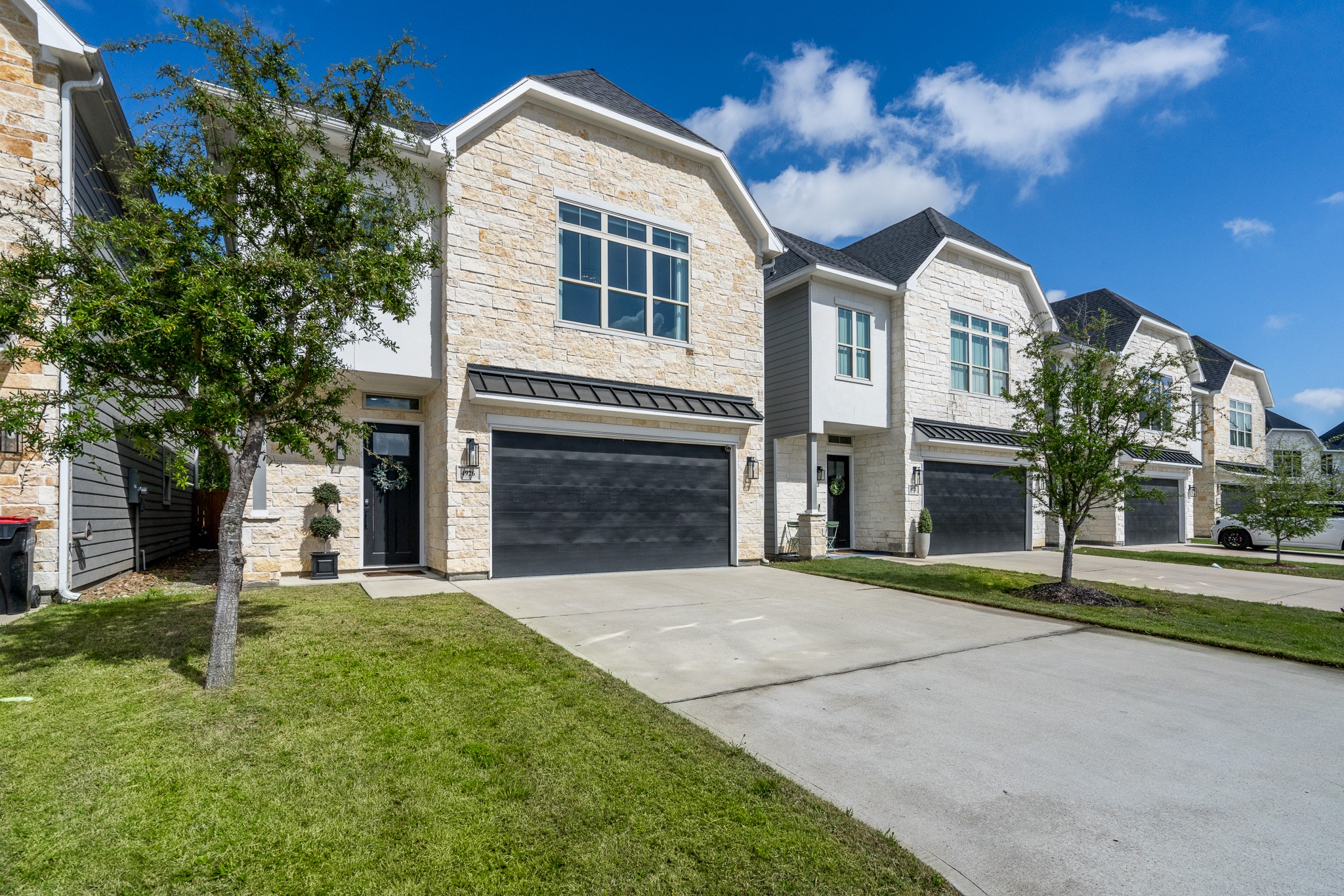 4926 Wunder Way Houston, TX 77069 - Photo 2 of 39 a front view of a house with a garden