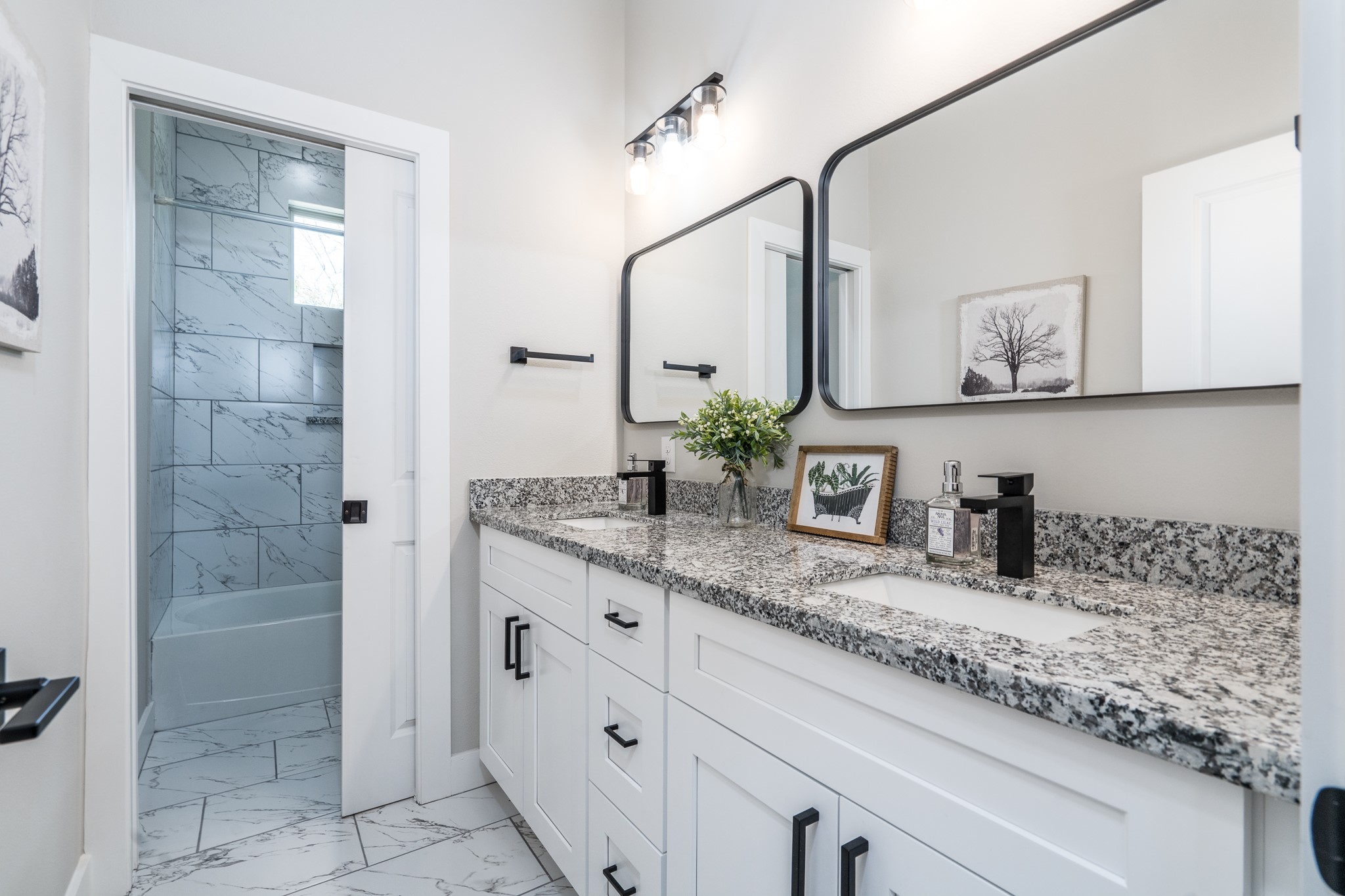 4926 Wunder Way Houston, TX 77069 - Photo 24 of 39 a bathroom with a granite countertop sink a mirror and shower