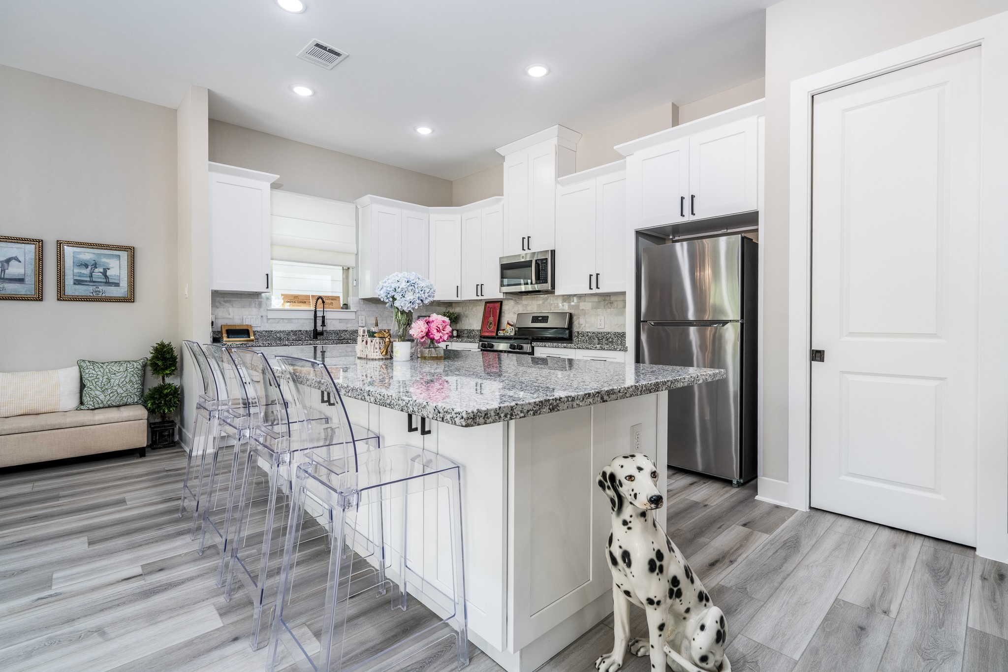 4926 Wunder Way Houston, TX 77069 - Photo 5 of 39 a kitchen with stainless steel appliances granite countertop a dining table chairs sink refrigerator and cabinets