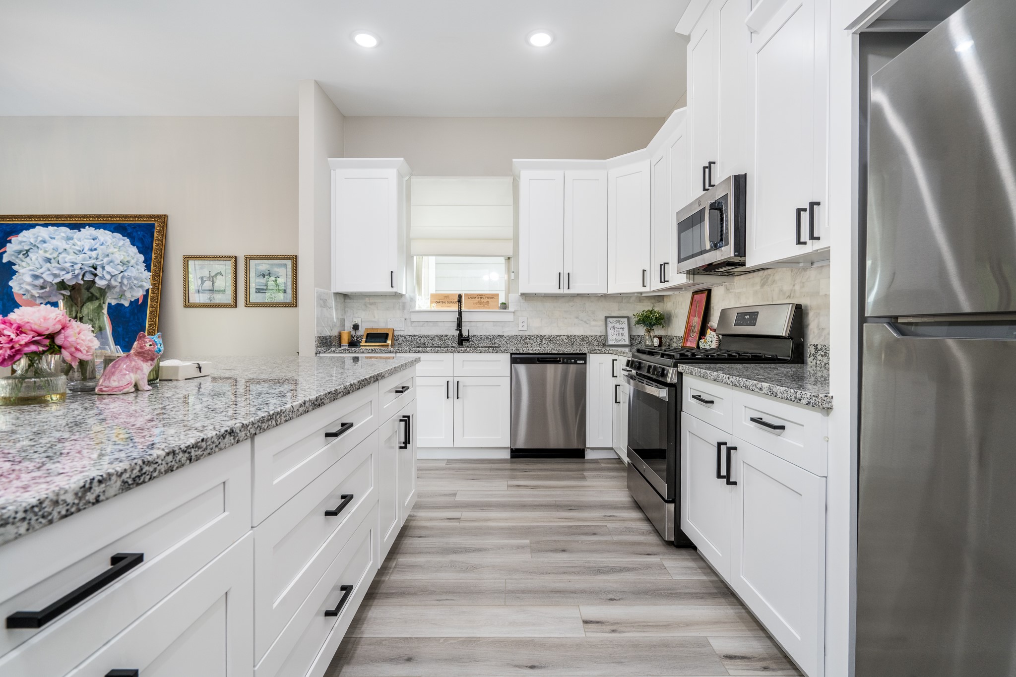 4926 Wunder Way Houston, TX 77069 - Photo 6 of 39 a kitchen with white cabinets and white appliances