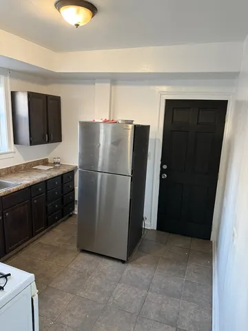 a kitchen with a sink and a refrigerator