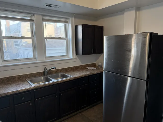 a kitchen with a refrigerator and a stove