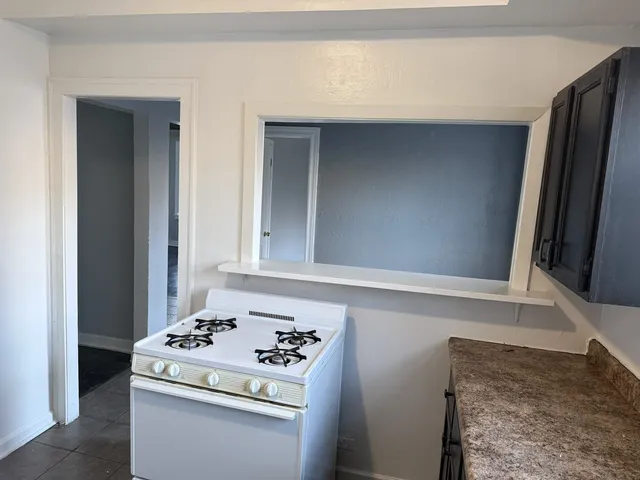 a bathroom with a bathtub a window and a shower