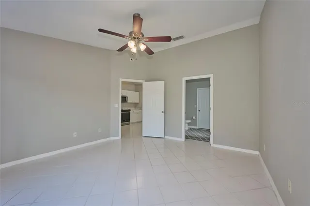 a view of an empty room with a fan