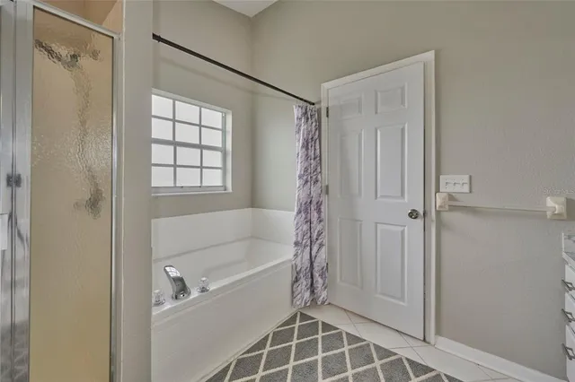 a bathroom with a bathtub and a shower