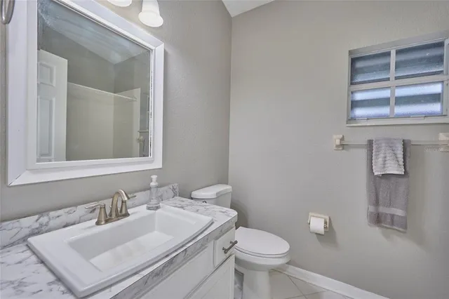 a bathroom with a sink toilet and mirror