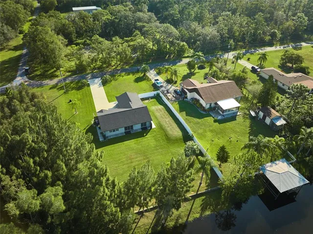 an aerial view of a house with a yard