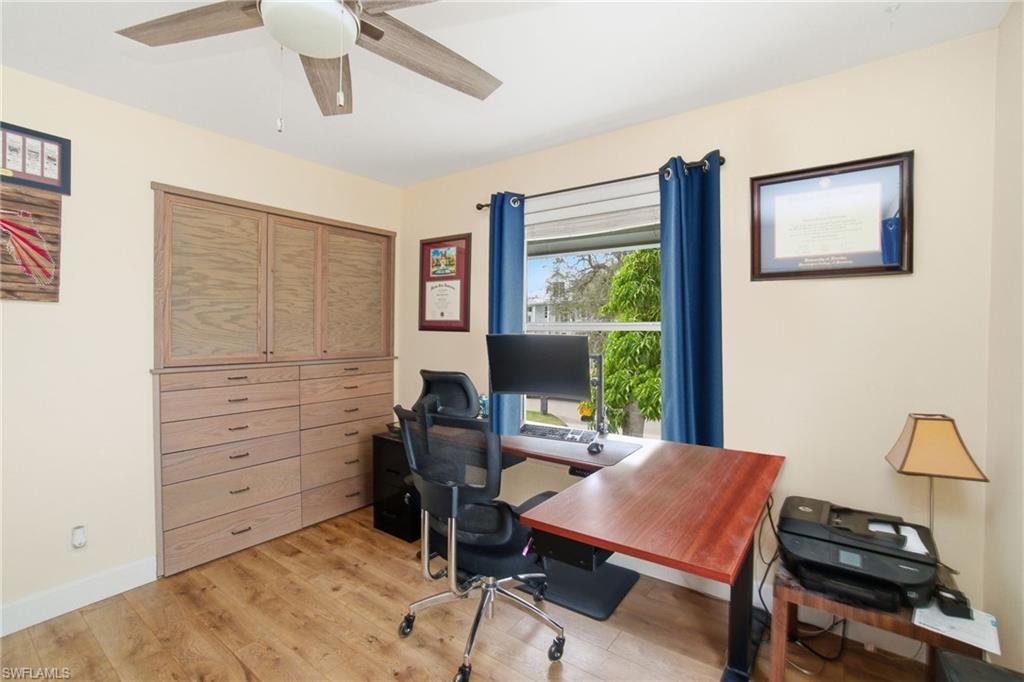 1286 Venetian Way Naples, FL 34110 - Photo 17 of 46 a view of a workspace with furniture and a window