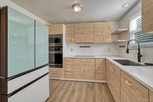 a kitchen with a sink a microwave and cabinets