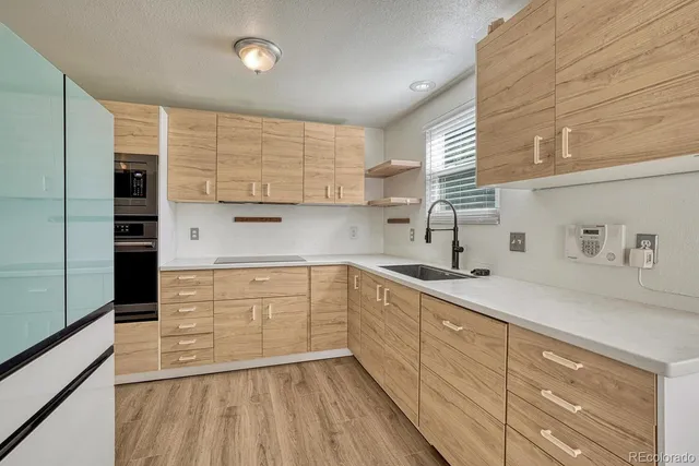 a kitchen with a sink window and cabinets