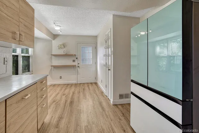 a view of a walk in closet and wooden floor