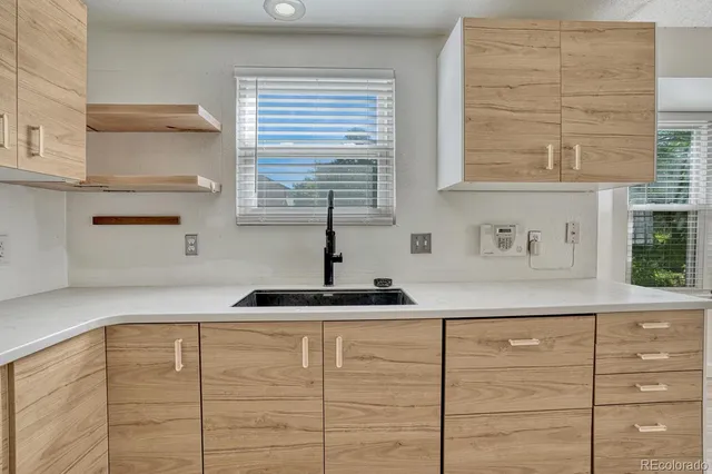 a kitchen with a sink and cabinets