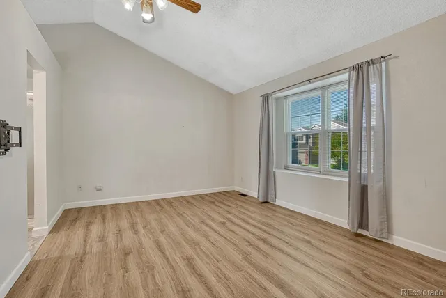 wooden floor in an empty room with a window