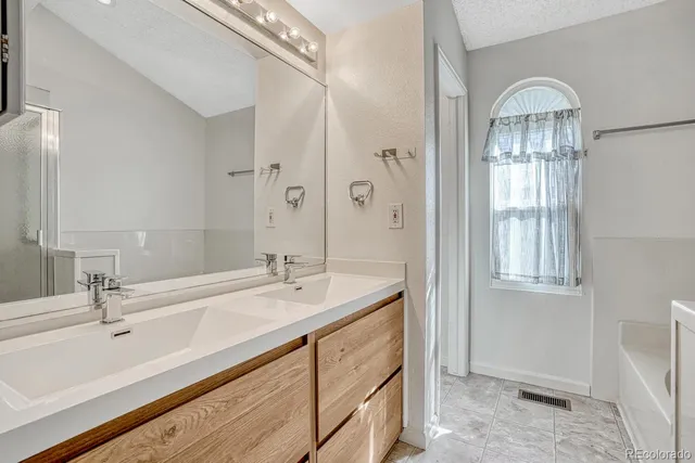 a bathroom with a sink double vanity and a mirror