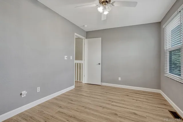wooden floor in an empty room with a window