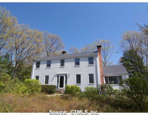 a front view of a house with trees