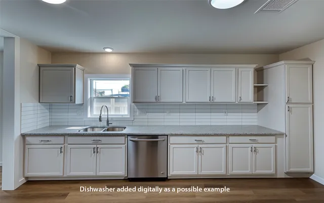 a kitchen with granite countertop a stove and a sink
