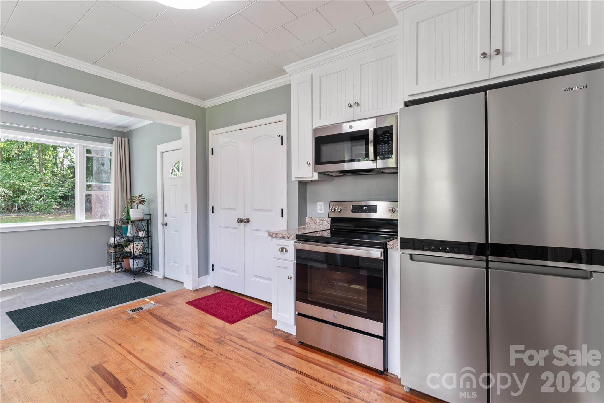 223 Wiley Avenue York, SC 29745 - Photo 12 of 40 a kitchen with granite countertop stainless steel appliances a refrigerator cabinets and a window