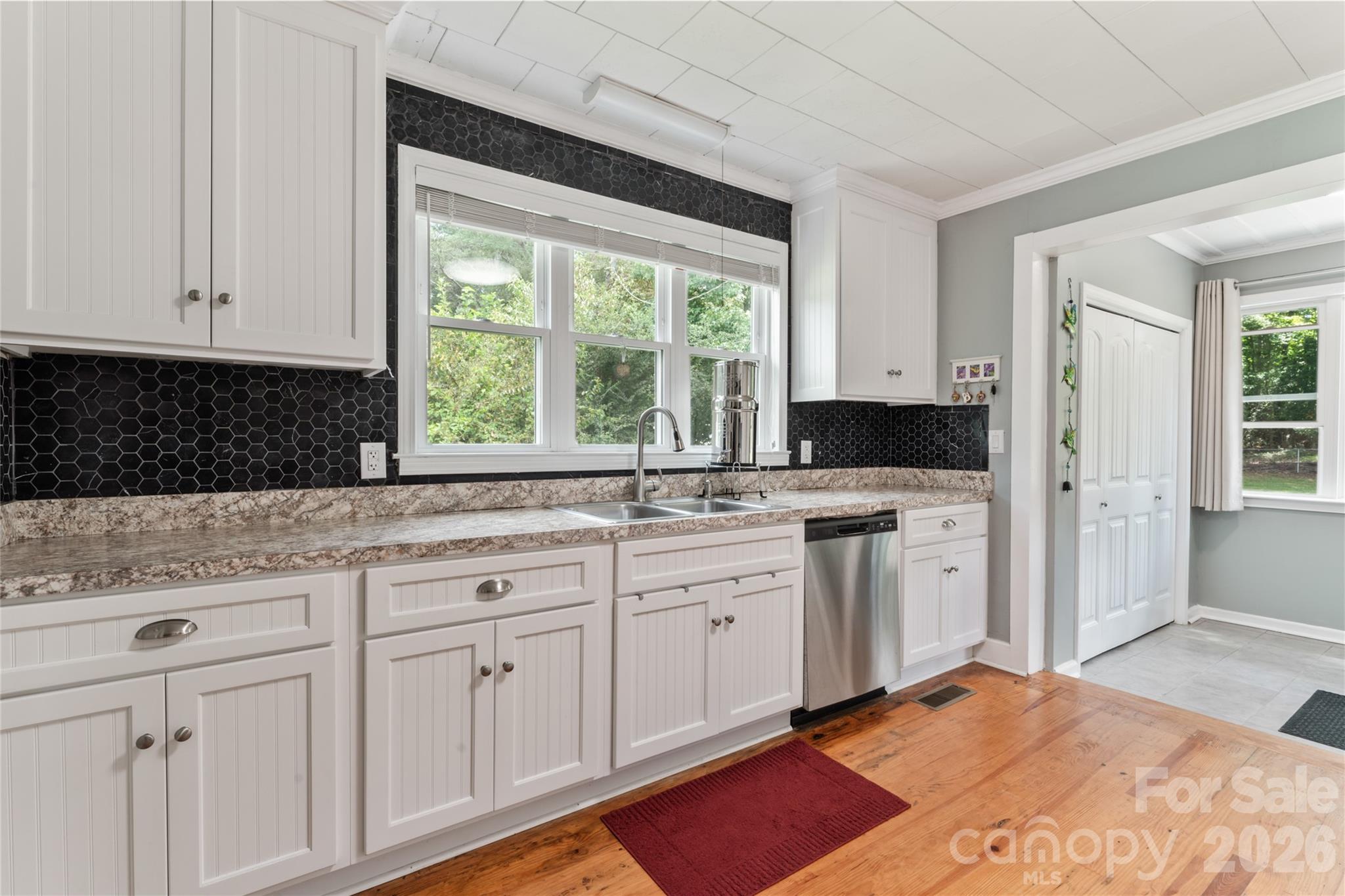 223 Wiley Avenue York, SC 29745 - Photo 13 of 40 a kitchen with white cabinets and a window