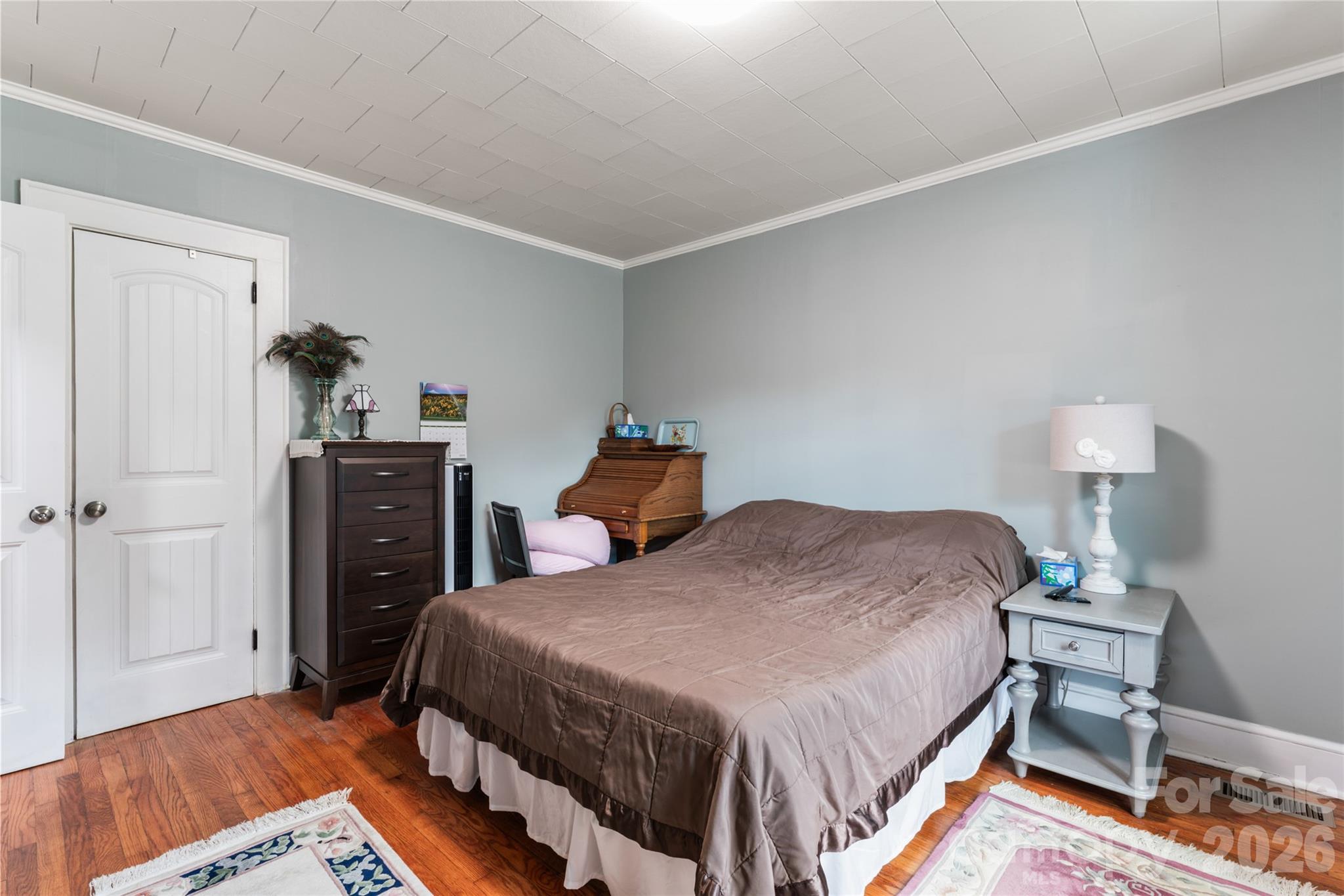 223 Wiley Avenue York, SC 29745 - Photo 20 of 40 a bedroom with a bed and wooden floor