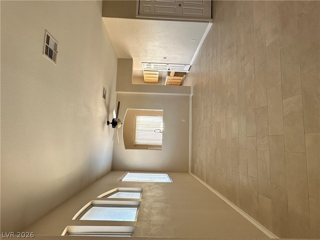 1922 Thunder Ridge Circle Henderson, NV 89012 - Photo 5 of 27 An airy great room features high ceilings, tile flooring, and ample natural illumination.