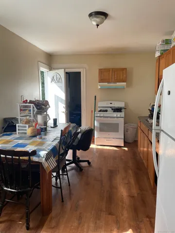 a kitchen with granite countertop a stove and chairs