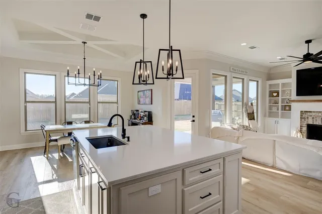 a kitchen with kitchen island granite countertop a sink appliances and a counter space