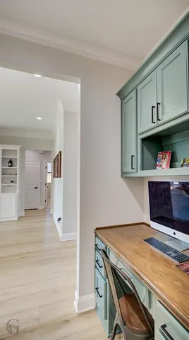 a room with wooden floor and cabinets