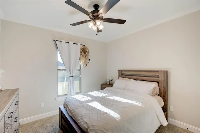 a bathroom with a granite countertop sink toilet and mirror