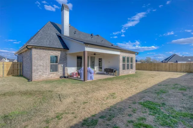 a view of a house with wooden fence