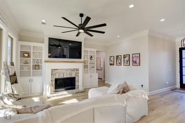a living room with furniture a fireplace and a flat screen tv