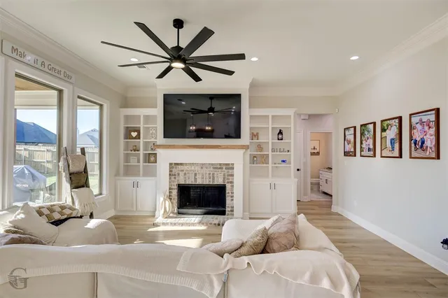 a living room with furniture a flat screen tv and a fireplace