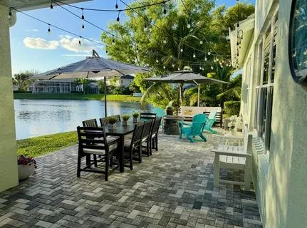 a view of a patio with table and chairs under an umbrella