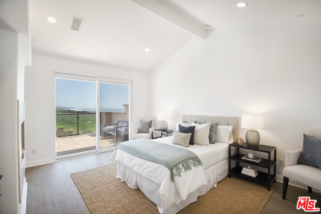 6450 Lunita Road, Unit 122 Malibu, CA 90265 - Photo 2 of 32 a bedroom with a large bed and a couch