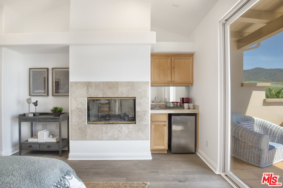 6450 Lunita Road, Unit 122 Malibu, CA 90265 - Photo 12 of 32 a living room with stainless steel appliances furniture a fireplace and a flat screen tv